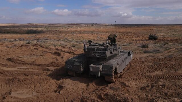 Drone View of an IDF Soldier getting into the cockpit of military tank vehicles in Israel