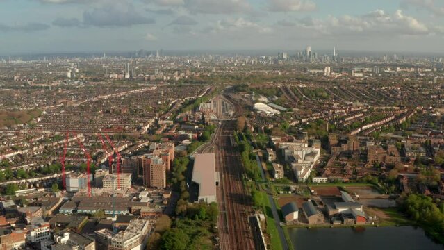 Aerial shot over North London train line near Hornsey towards city centre skyline