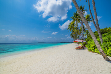 Beautiful island beach. Couple chairs on sandy beach, sunny sea sky palms. Summer holiday, vacation destination concept. Inspire tropical nature landscape. Tranquil relaxing beach exotic luxury scenic