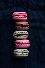 Macaroons on dark background, colorful french cookies macaroons