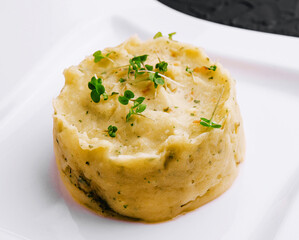 Mashed potatoes with pesto on white plate