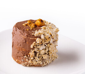 Kiev cake with walnuts on white plate