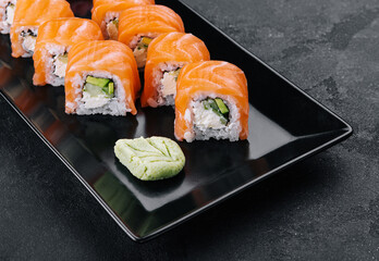 Delicious philadelphia sushi on black stone plate