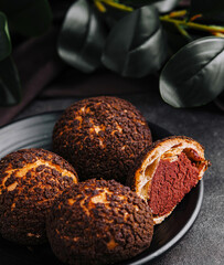 PoofPoof Butterscotch on black plate on stone