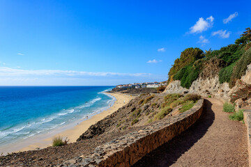Stunning View of Beach and Sea with Blue Sky from Stone Promenade in Esquinzo, Fuerteventura