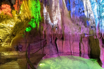 Majestic little lake inside the Hoellengrotten caves with lights illuminated in Baar in Switzerland