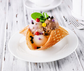 Three scoops of natural organic fruit ice cream in a wafer cup