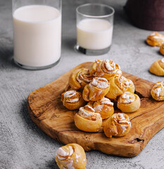 Appetizing ruddy buns-roses and milk bottle