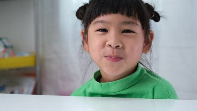 Happy cute little girl eating gelatin candy. Funny kid with chewing gum. Beautiful little girl with with vitamins for children like jelly candy.
