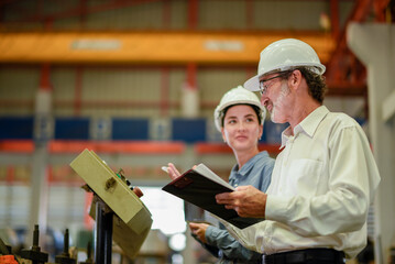 woman engineer assistant secretary in helmet inspection check control heavy machine construction installation in industrial factory with boss manager. Boss and partnership check maintenance factory