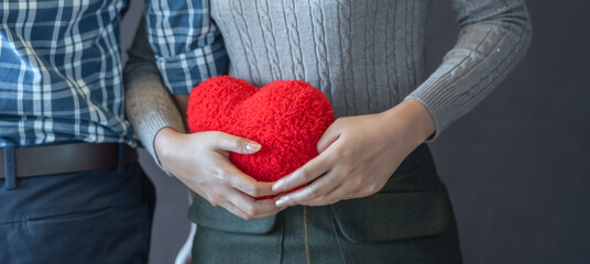 banner of Lover couple happy in love relaxing on sofa looking in eye smiling teasing with big red...