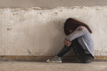 depression sad alone woman sit in dirty abandon building after raped violence against by bandit....
