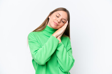 Young beautiful blonde woman isolated on white background making sleep gesture in dorable expression