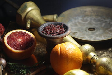 bowl of tobacco for hookah. smoking nargile. berries and fruits on a dark background