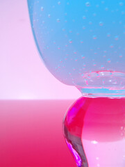 Close up of textured wine glass with colorful lighting