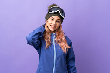Skier teenager girl with snowboarding glasses over isolated purple background laughing