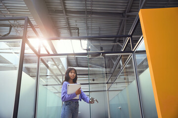 Fototapeta premium Beautiful female entering to room in office