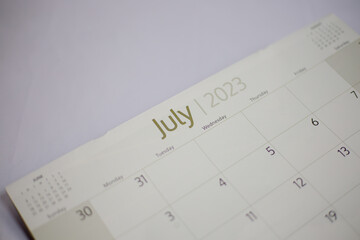Selective focus shot of a closeup calendar of July 2023. June 2023 calendar isolated on background. 