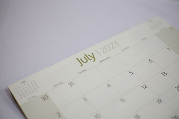 Selective focus shot of a closeup calendar of July 2023. June 2023 calendar isolated on background. 