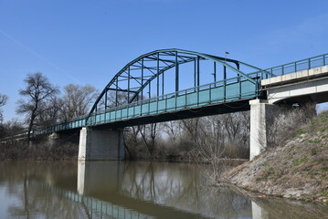 Fototapeta na wymiar Green metal bridge in Panchevo, Serbia, acrois river Tamis