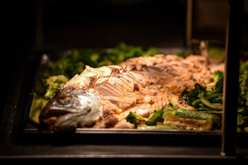 Salmon fillet with fresh vegetables ready to be served at event
