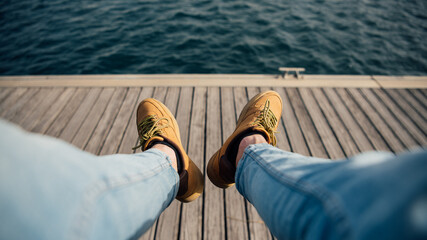 POV view of legs out looking at the sea in the harbor