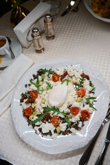 Serving of delicious salad with poached egg on top