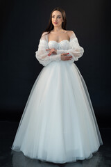 Fototapeta na wymiar Perfect bride in wedding dress on black background