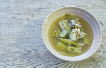 boiled pickled cabbage with pork bone in clear soup on bowl
