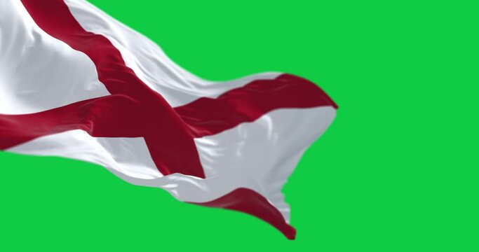 Alabama state flag waving isolated on a green background