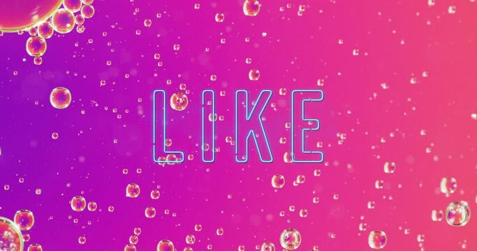 Animation of like neon text over close up of baubles on pink background
