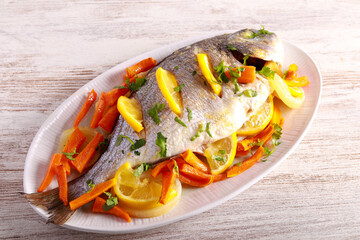 Baked dorada sea bream fish with lemon