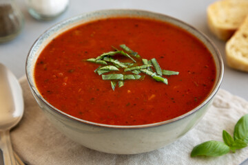 Homemade Tomato Basil Soup in a Bowl, low angle view. Close-up.
