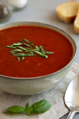 Homemade Tomato Basil Soup in a Bowl, low angle view. Close-up.