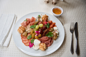 Close-up plate with different sausages, meat and cheese, antipasto
