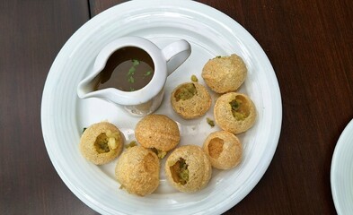 Delicious favorite north and south indian street food pani puri gol gappa with tamarind waterwaters - obrazy, fototapety, plakaty