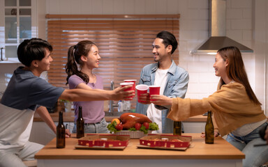 Group of Asian friends enjoying an evening party together at home.	
