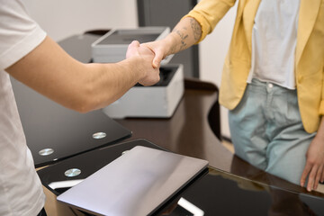 Man and woman shaking hands in the office