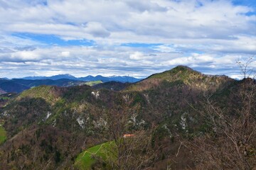 Fototapeta na wymiar Tošc hill in pre-alpine Slovenia in Polhov Gradec hills with stratocumulus clouds in the sky
