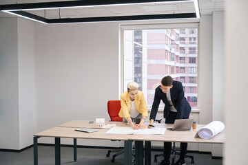 Architects drawing building plan in the office
