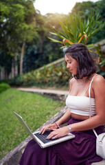 portrait beautiful young woman working on her notebook outside concentrated