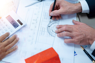 engineer working in office with blueprints, inspection in workplace for architectural plan, construction project ,Business construction