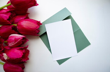 Greeting, postcard, birthday, wedding invite mock up white card with the bouquet of pink tulips