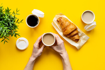 Obraz na płótnie Canvas Many paper cups coffee to go with fresh croissant