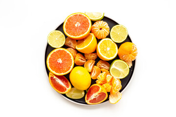 Many different citrus fruits leaves on white background, top view