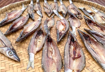 Dried fish under the sun on a rattan tray