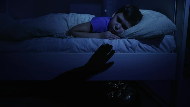 Monster under little boy's bed