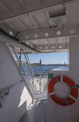 View from a commuting boat, life saver with text Stockholm, and the down town in skyline, a sunny...