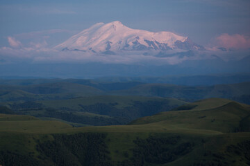 snowy peak of Mount Elbrus on background of green foothills. beautiful natural mountain landscape