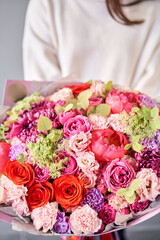 Beautiful bouquet of mixed flowers in woman hand. Floral shop concept . Beautiful fresh cut bouquet. Flowers delivery